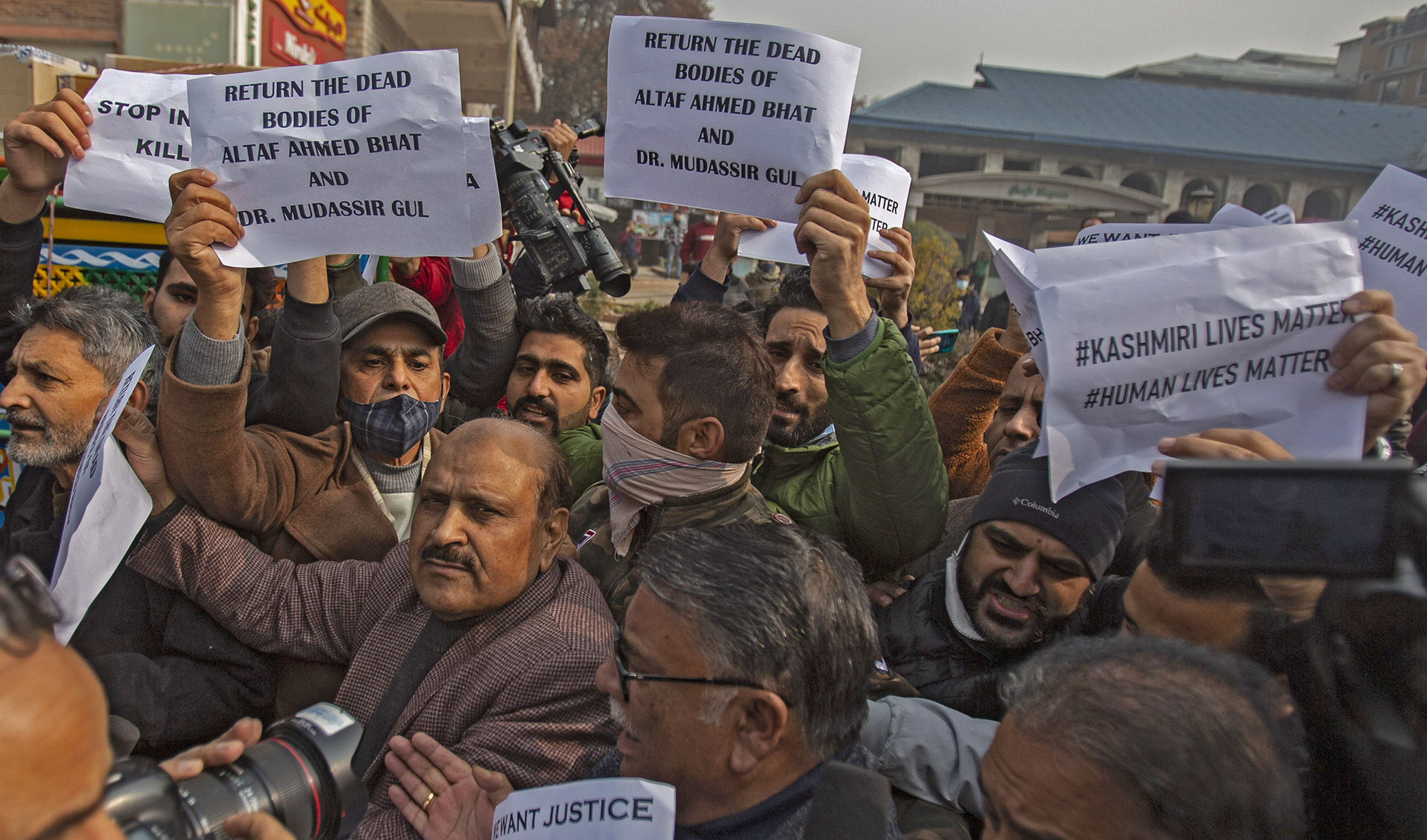 Members of Jammu and Kashmir People's Conference hold placards as they shout slogans during a protest demanding the return of dead bodies of civilians for proper burial, in Srinagar, Indian-controlled Kashmir, on November 18, 2021. (AFP)