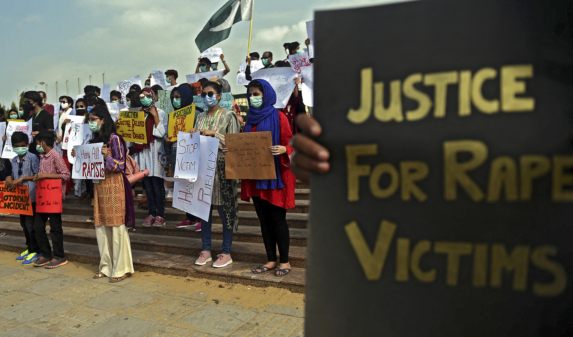 Members of VCare Welfare Trust hold placards during a protest against an alleged gang rape of a woman, in Karachi, Pakistan, on September 13, 2020. (AFP/File)