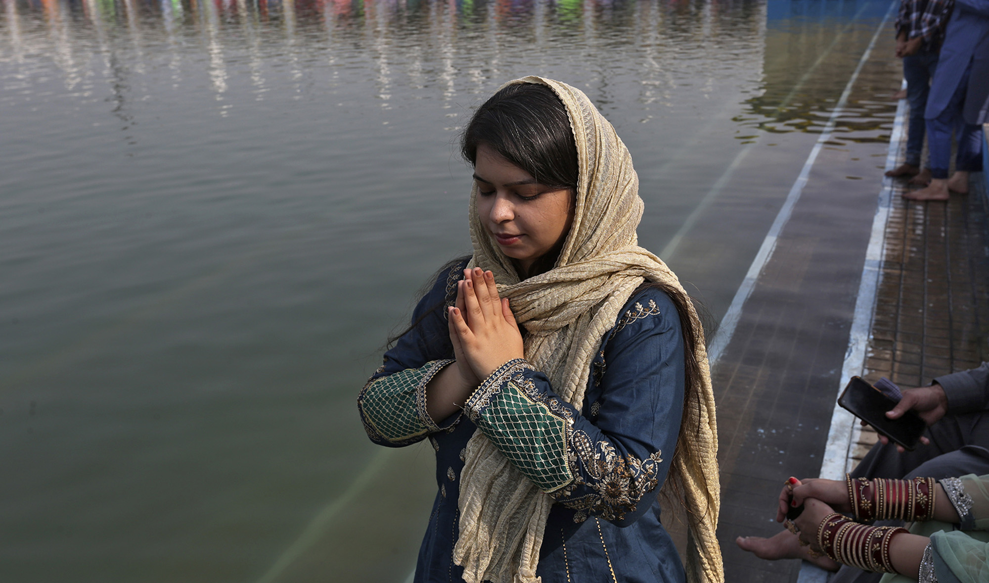A Sikh woman performs rituals during a ceremony to celebrate the birth anniversary of the founder of her faith in Nankana Sahib near Lahore, Pakistan, on Friday, November 19, 2021. (AP)