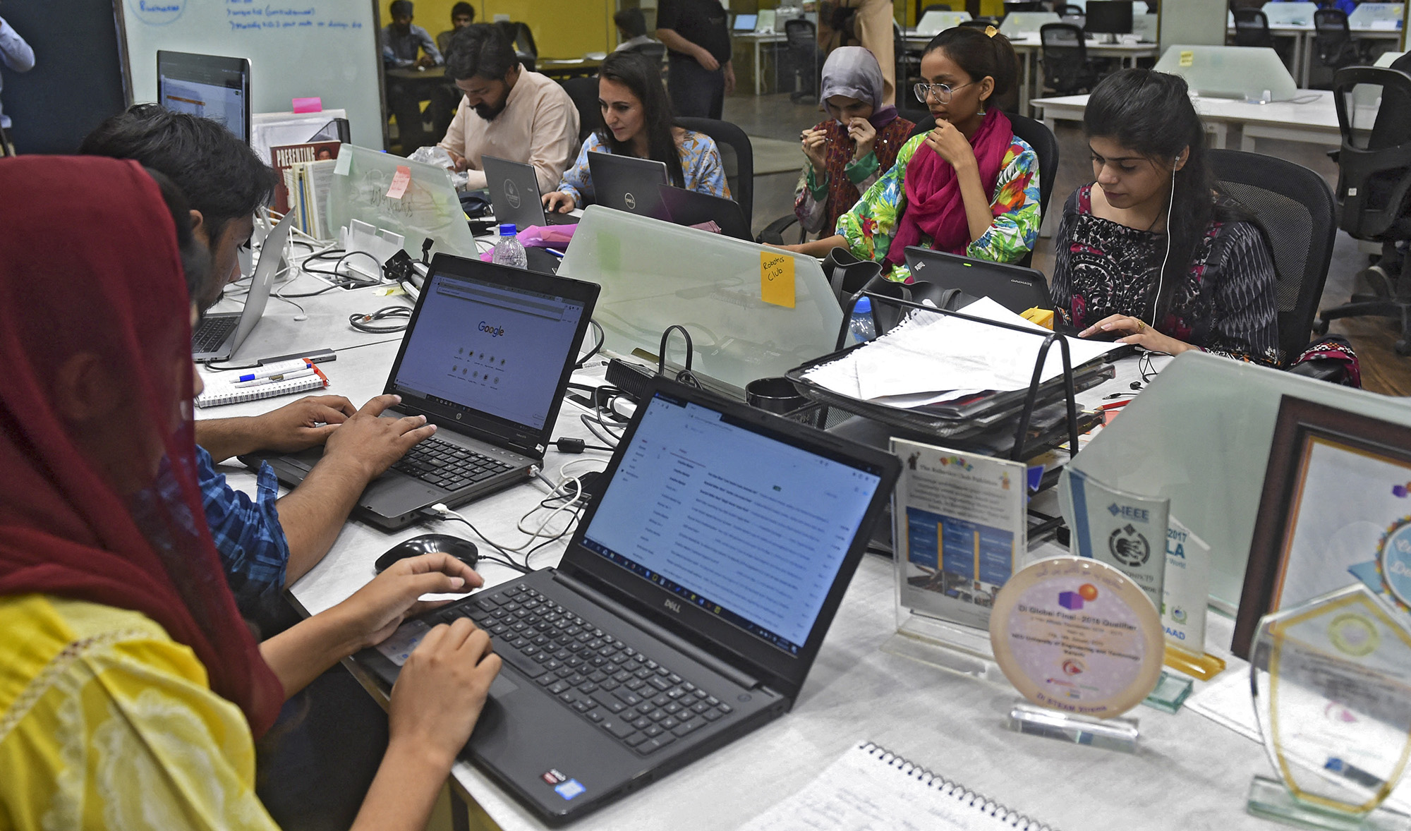 People work at their stations at the National Incubation Centre (NIC) in Lahore, Pakistan, on May 24, 2019. (AFP/File)
