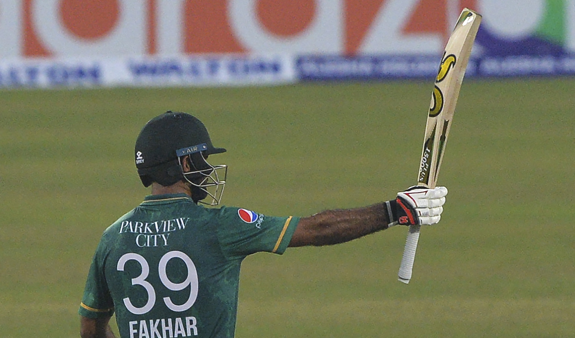 Pakistan's Fakhar Zaman raises his bat to celebrate a half century (50 runs) during the second Twenty20 international cricket match between Bangladesh and Pakistan at the Sher-e-Bangla National Cricket Stadium in Dhaka on November 20, 2021. (AFP)