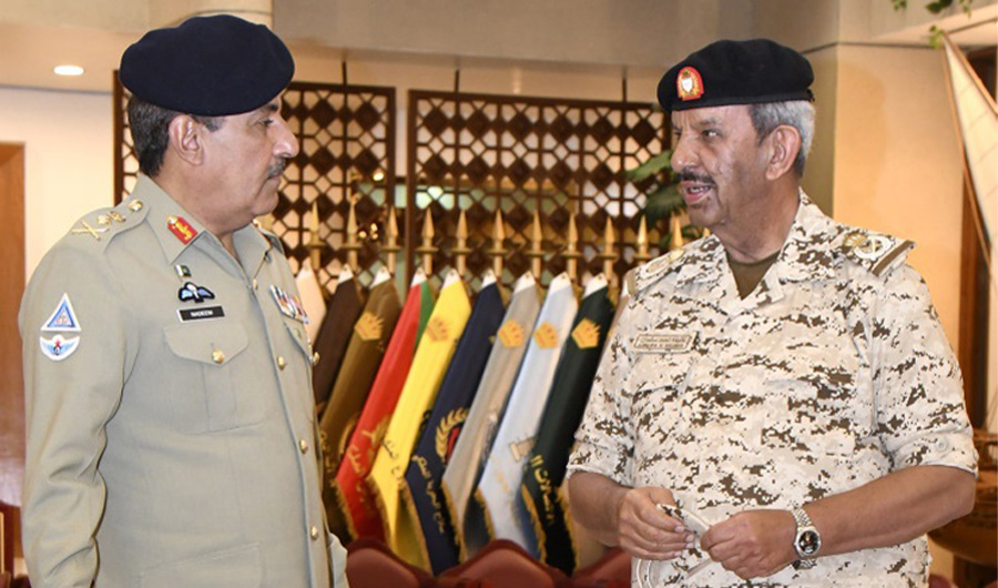 Bahrain's National Guard President General Shaikh Mohammed bin Isa Al Khalifa (R) speaks to Pakistan’s Joint Chiefs of Staff Committee Chairman General Nadeem Raza (L) in Bahrain on Nov 23, 2021. (Bahrain News Agency)