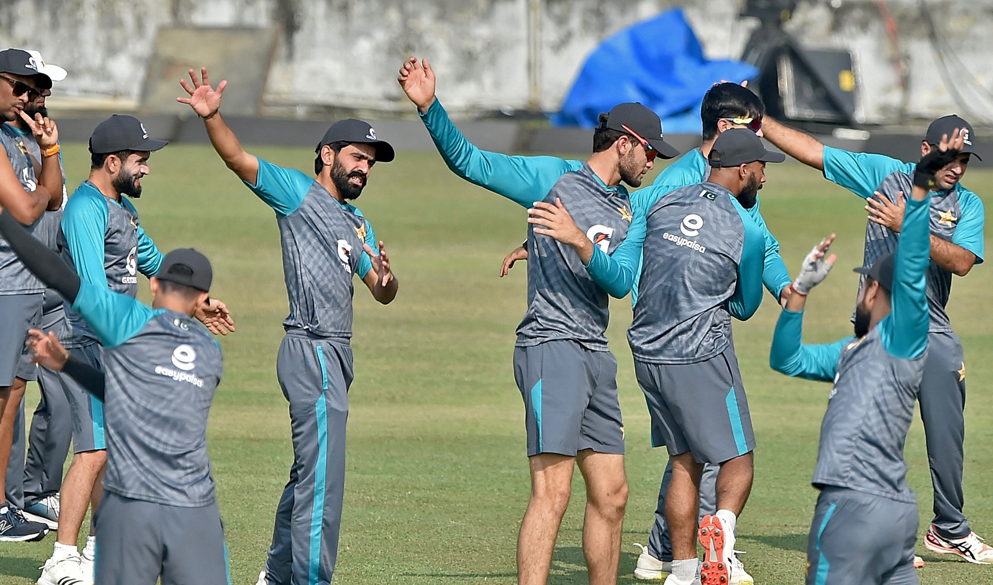 Pakistan’s cricketers stretch during a practice session ahead of their first Test cricket match at the Zahoor Ahmed Cricket Stadium in Chittagong, Bangladesh, on November 25, 2021. (AFP)