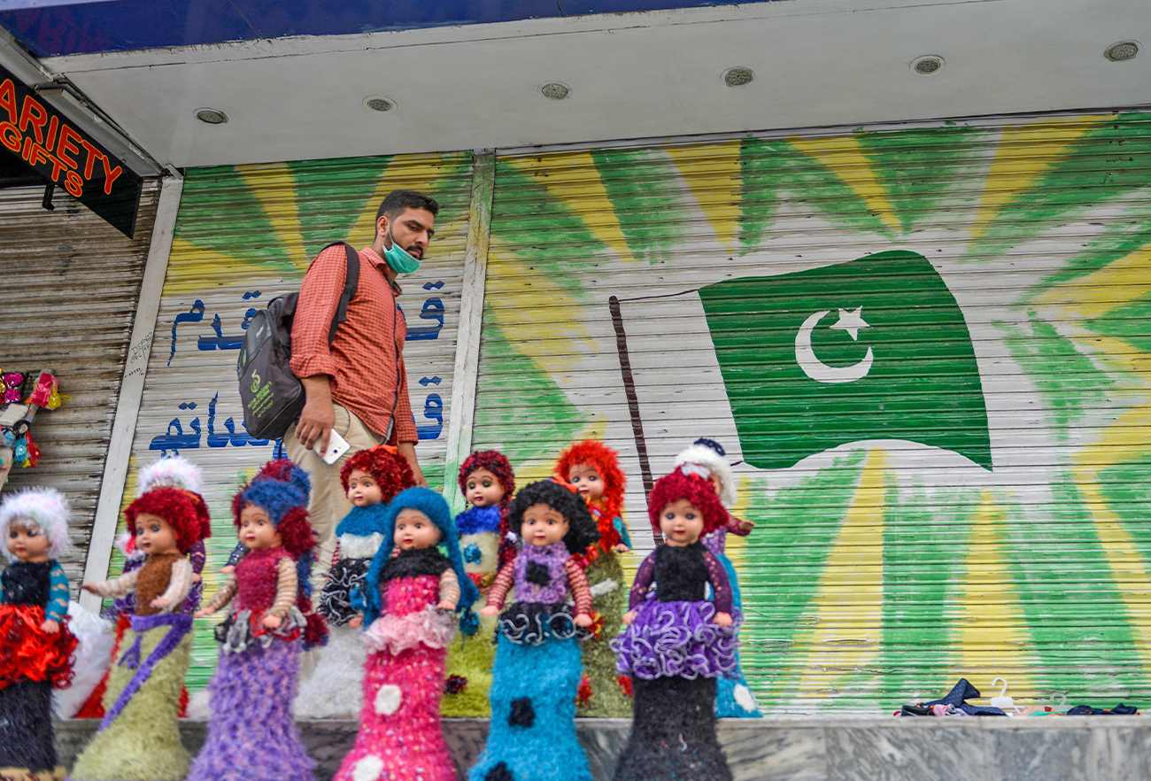 A Pakistani man walks past a shuttered market in Rawalpindi city, Pakistan, on July 29, 2020, (AFP/File)