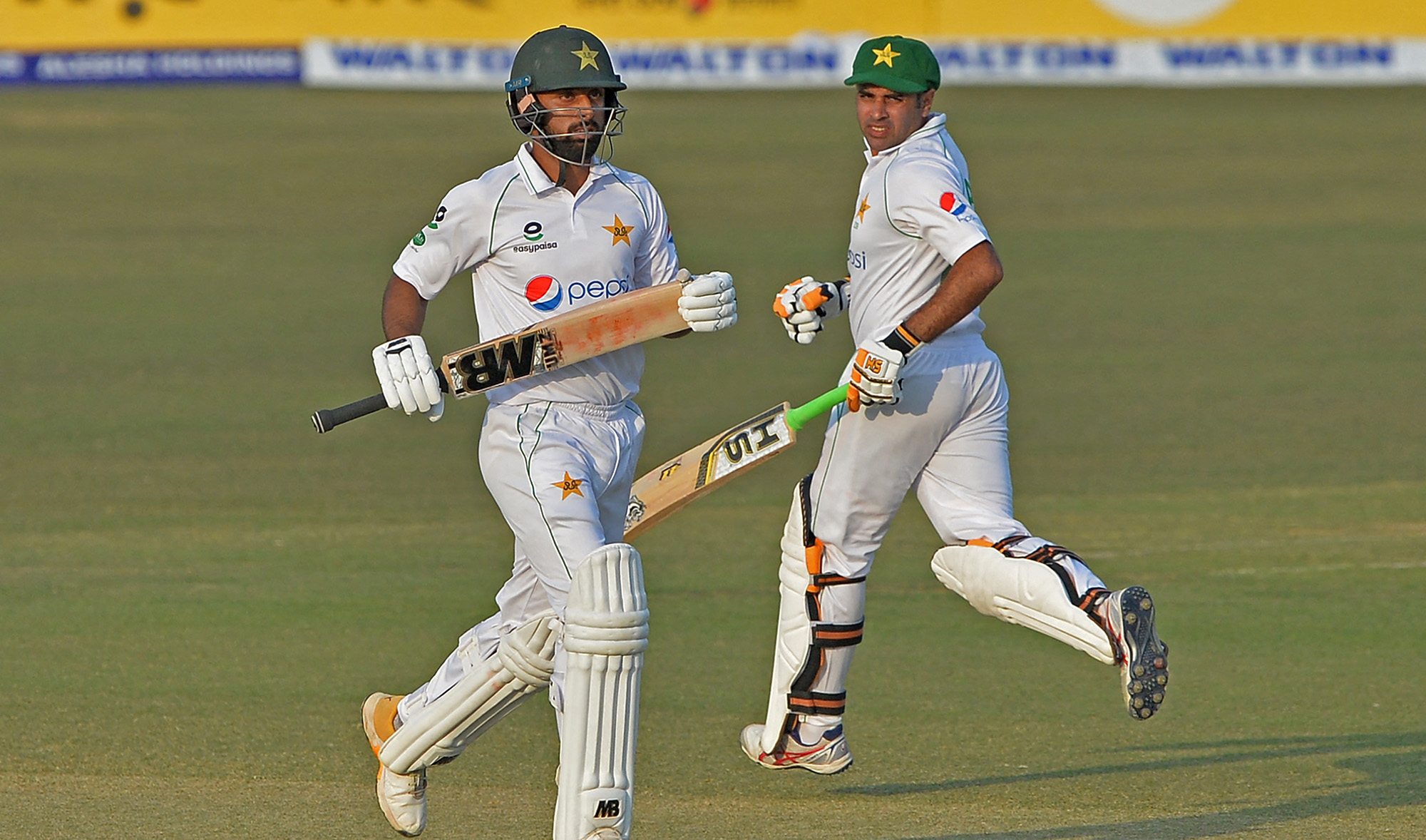 Pakistan's Abid Ali, right, and teammate Abdullah Shafique run between the wickets on the second day of the first Test cricket match against Banglades in Chittagong on November 27, 2021. (AFP/File)
