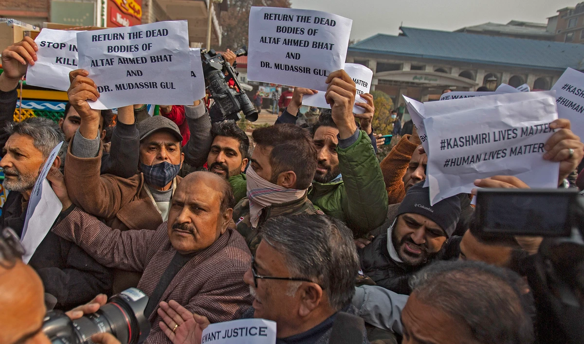 Members of Jammu and Kashmir People's Conference hold placards as they shout slogans during a protest demanding the return of dead bodies of civilians for proper burial, in Srinagar, Indian-controlled Kashmir, on November 18, 2021. (AFP)