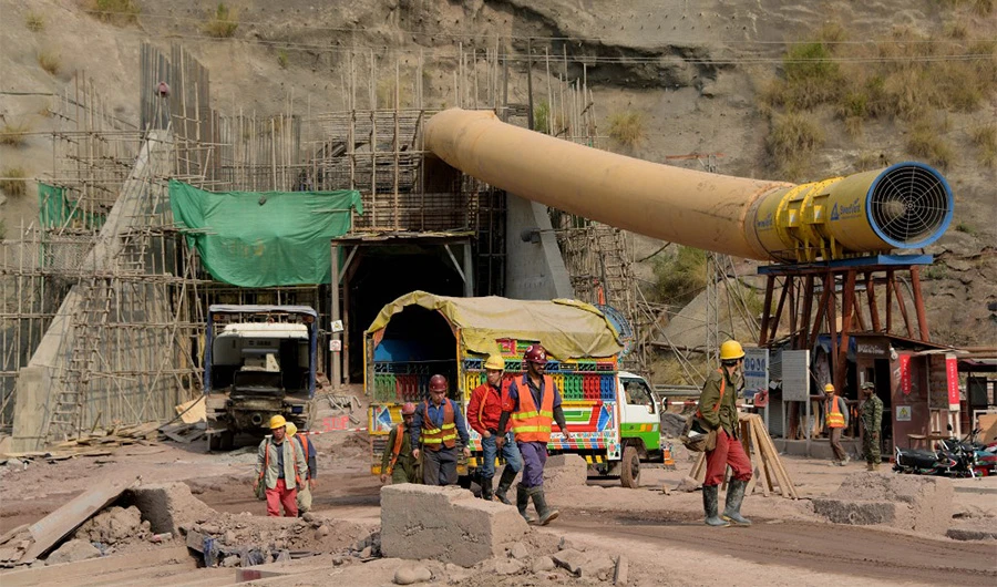 Chinese & Pakistani engineers walking next to the entrance point of the power distribution point of the Neelum-Jhelum Hydropower Project in Chattar Klass on the outskirts of Muzaffarabad in Azad Kashmir on Nov 17, 2017. (AFP/File)