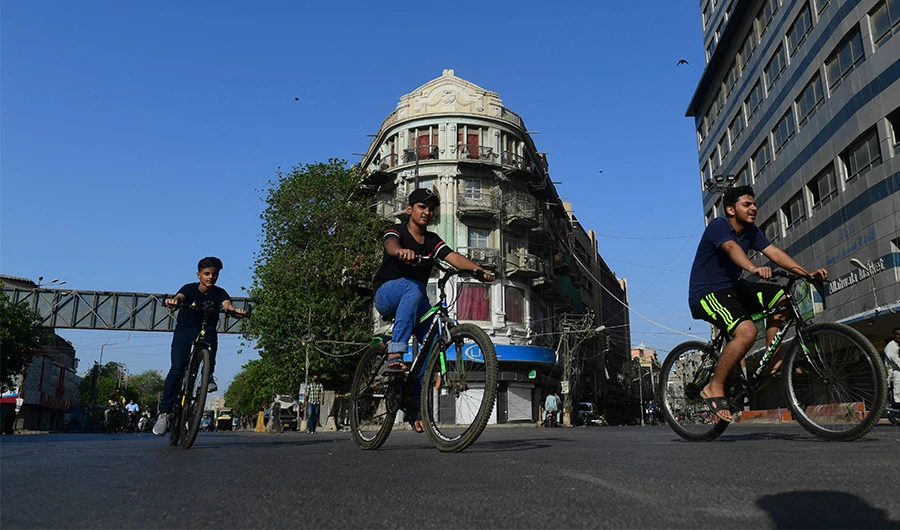 Pakistani youths ride their bicycles along a street in Karachi on May 2, 2021. (AFP/ File)