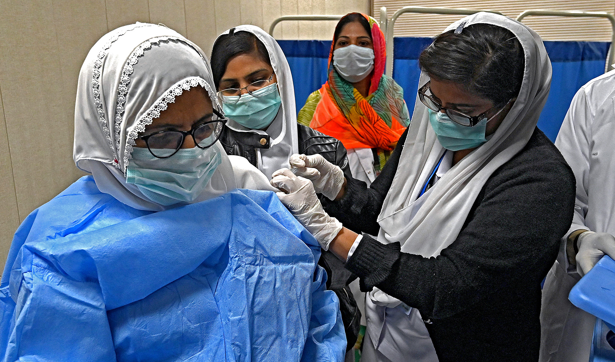 A doctor receives a dose of the Chinese-made Sinopharm Covid-19 vaccine, at a vaccination centre in Lahore, Pakistan, on February 3, 2021. (AFP/File)