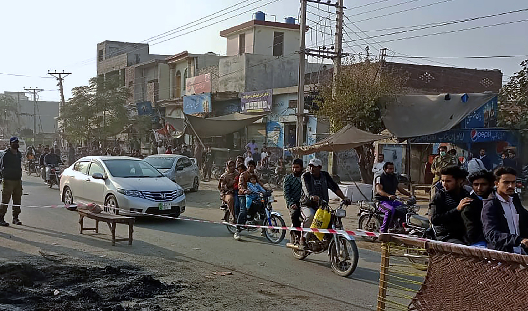 Police officers stand guard at the site where a Sri Lankan citizen lynched by a mob outside a factory in Sialkot, Pakistan on December 3, 2021. (AP)