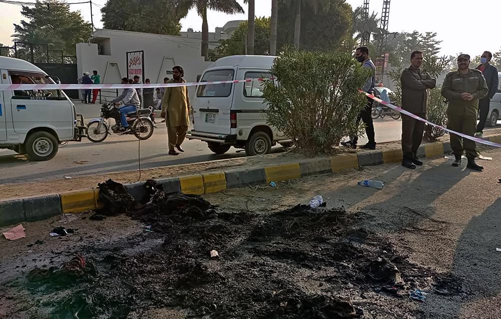 Police officers stand guard at the site where a Sri Lankan citizen was lynched by Muslim mob outside a factory in Sialkot, Pakistan, Friday, Dec. 3, 2021. (AP)