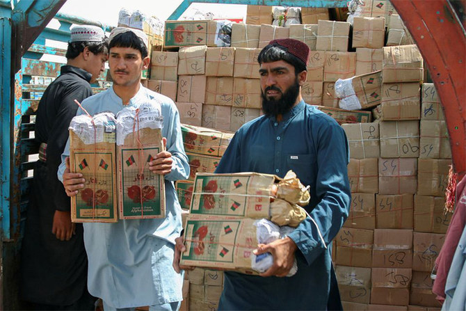 Labourers unload boxes of pomegranates from Afghanistan, from a truck at the 'Friendship Gate' crossing point, in the Pakistan-Afghanistan border town of Chaman, Pakistan, September 7, 2021. (REUTERS)