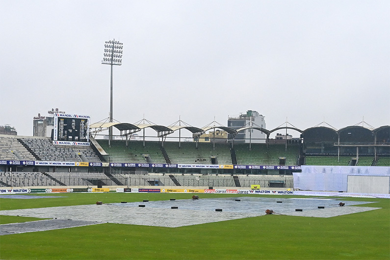 The pitch is covered with plastic sheets as rain interrupts the start of the third day of the second Test cricket match between Bangladesh and Pakistan at the Sher-e-Bangla National Cricket Stadium in Dhaka on December 6, 2021. (AFP)