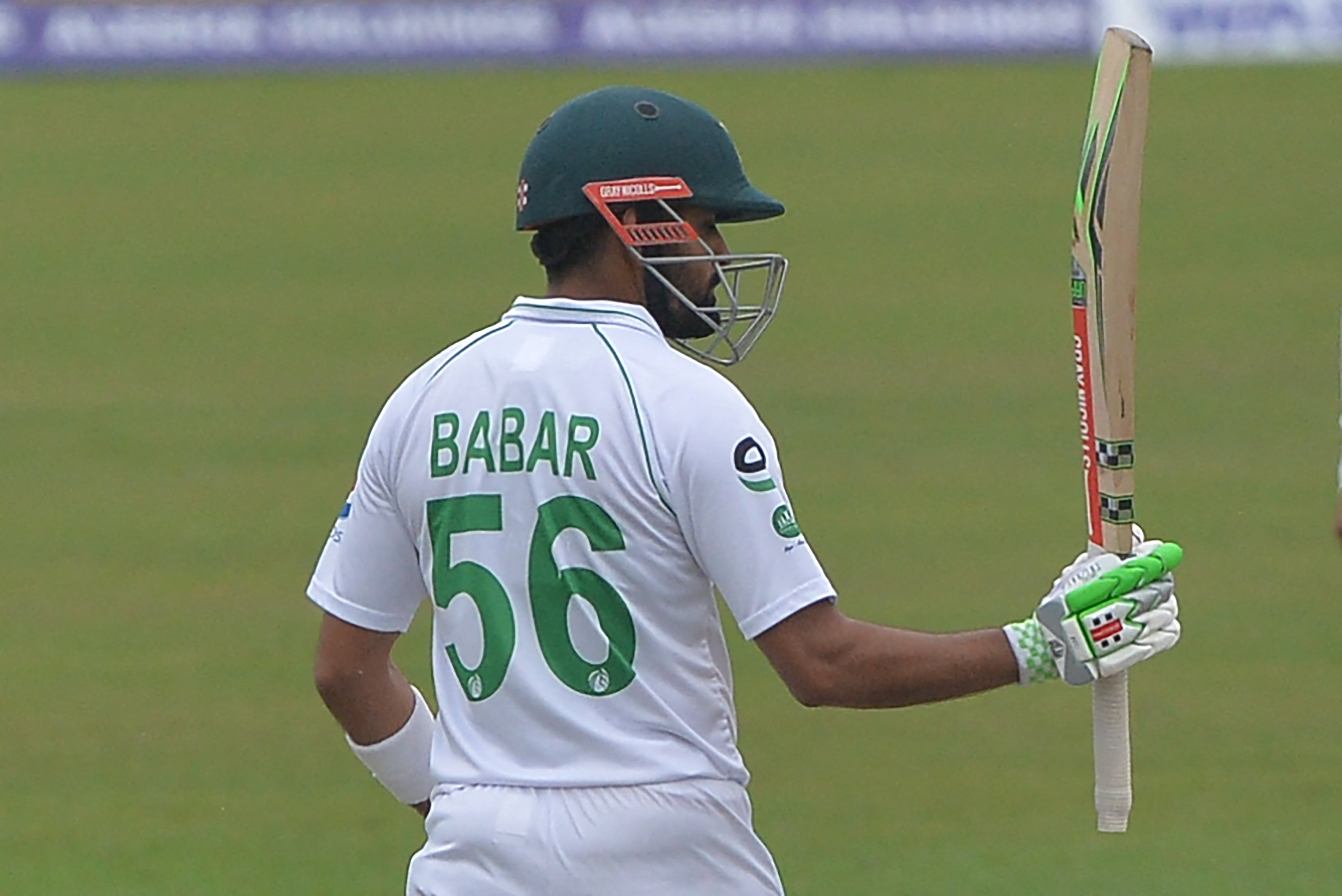 Pakistan's captain Babar Azam celebrates after scoring a half-century (50 runs) on the first day of the second Test cricket match between Bangladesh and Pakistan at the Sher-e-Bangla National Cricket Stadium in Dhaka on December 4, 2021. (AFP)