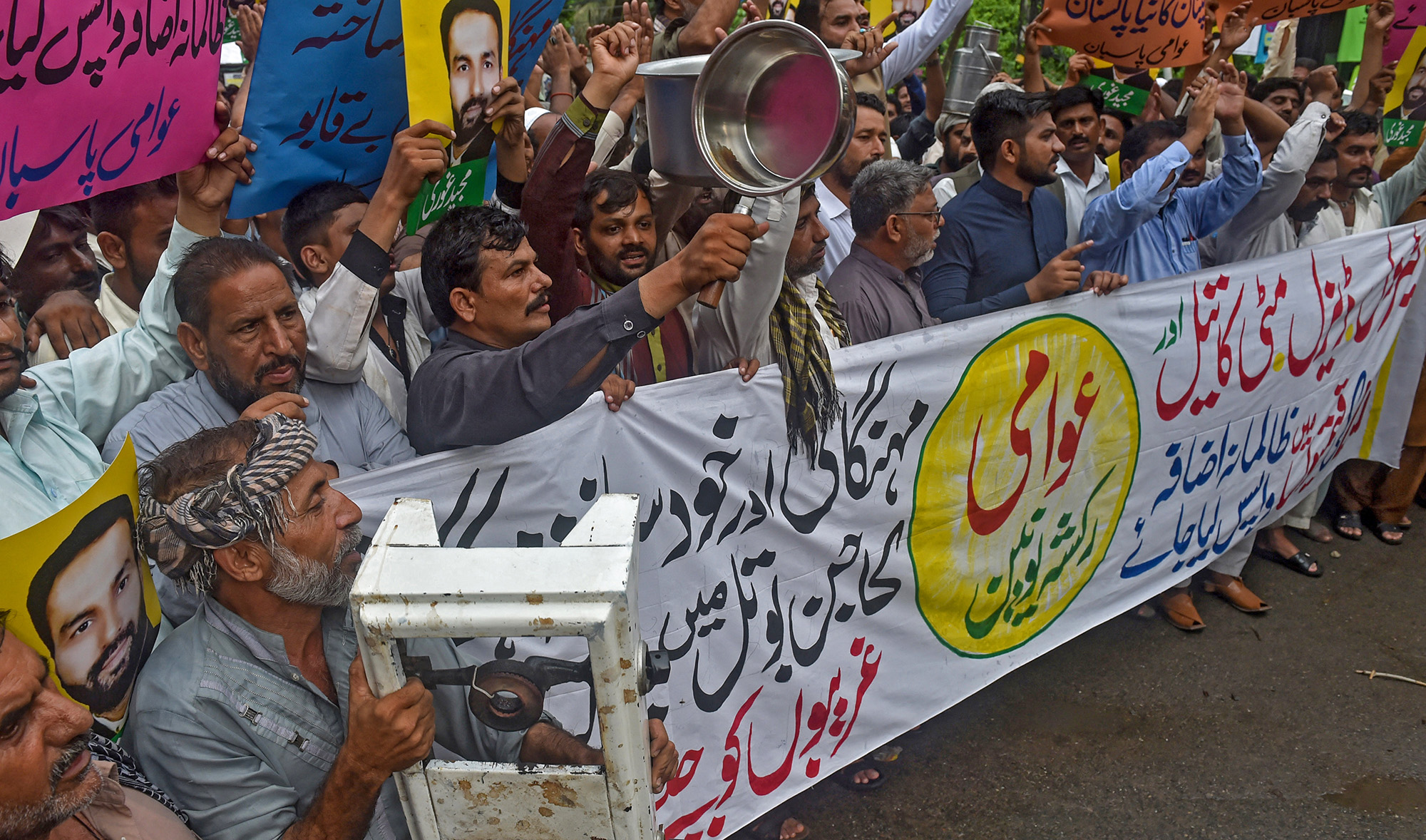 Auto-rickshaw drivers shout slogans during a protest against Imran Khan's government price hikes in Lahore, Pakistan, on August 1, 2019. (AFP/File)