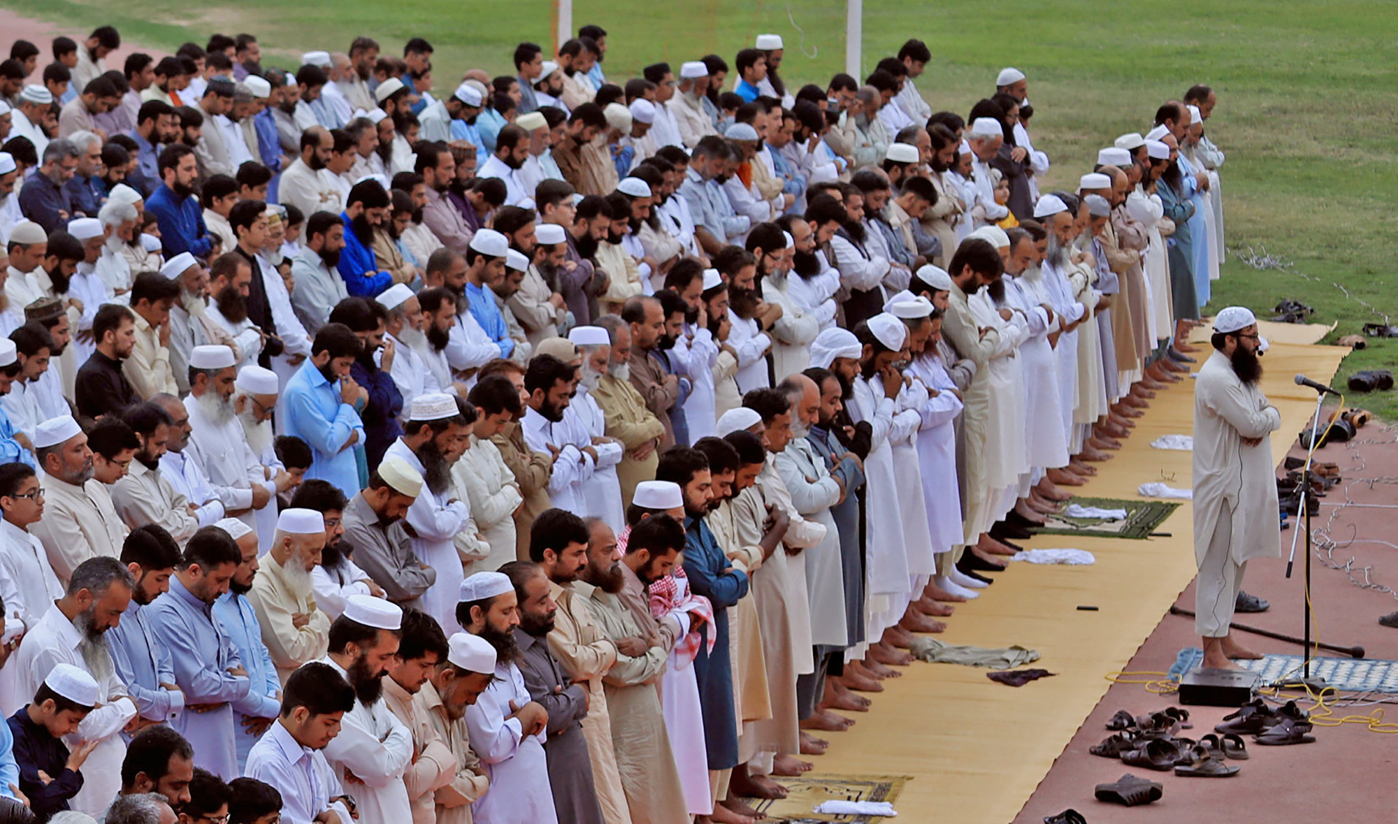 Residents attend Eid al-Adha prayers at a playground in Peshawar, Pakistan, on August 22, 2018. (REUTERS/File)