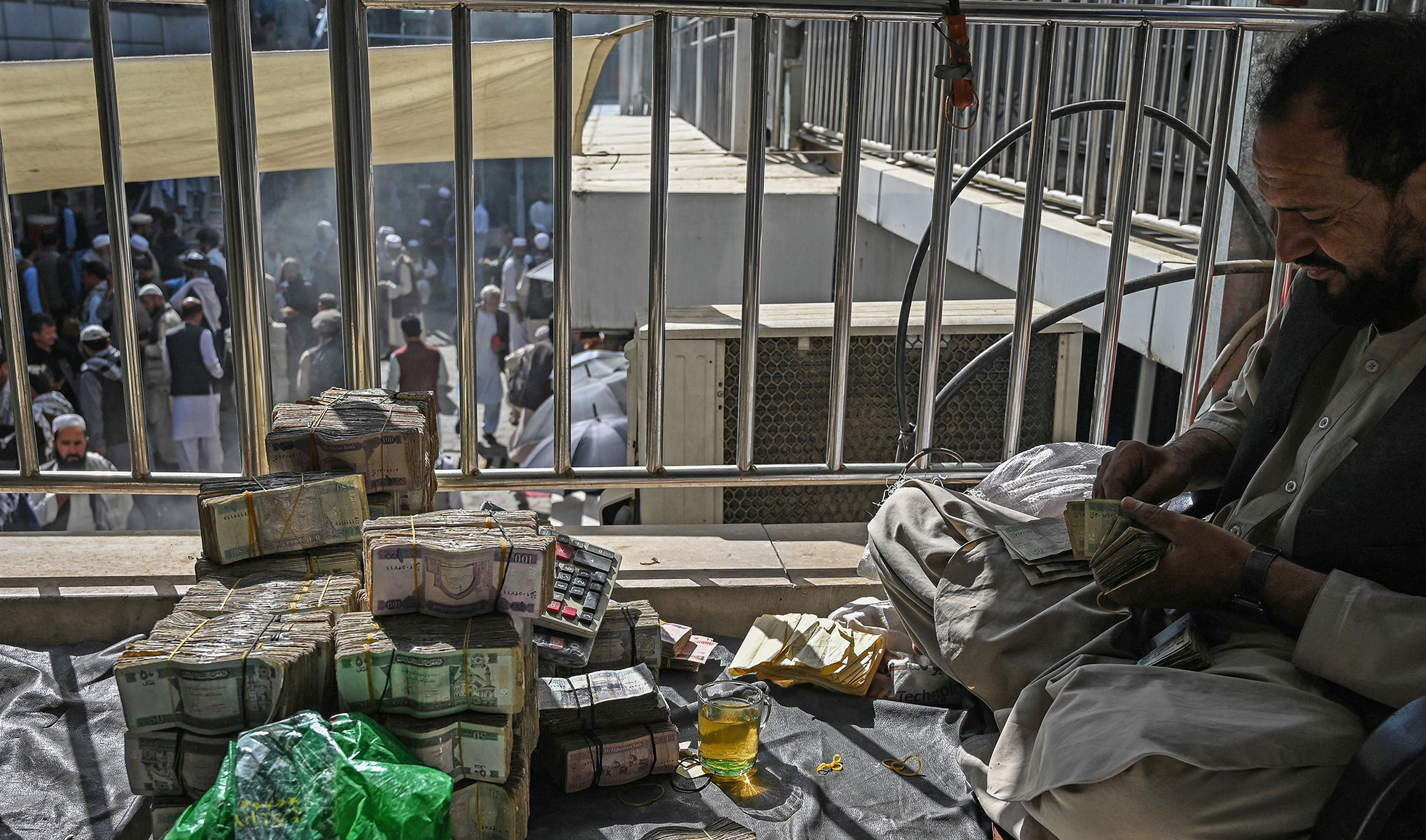 Afghan currency exchange dealers carry out their tasks after money exchange market reopens for business in Kabul on September 5, 2021. (AFP/File)