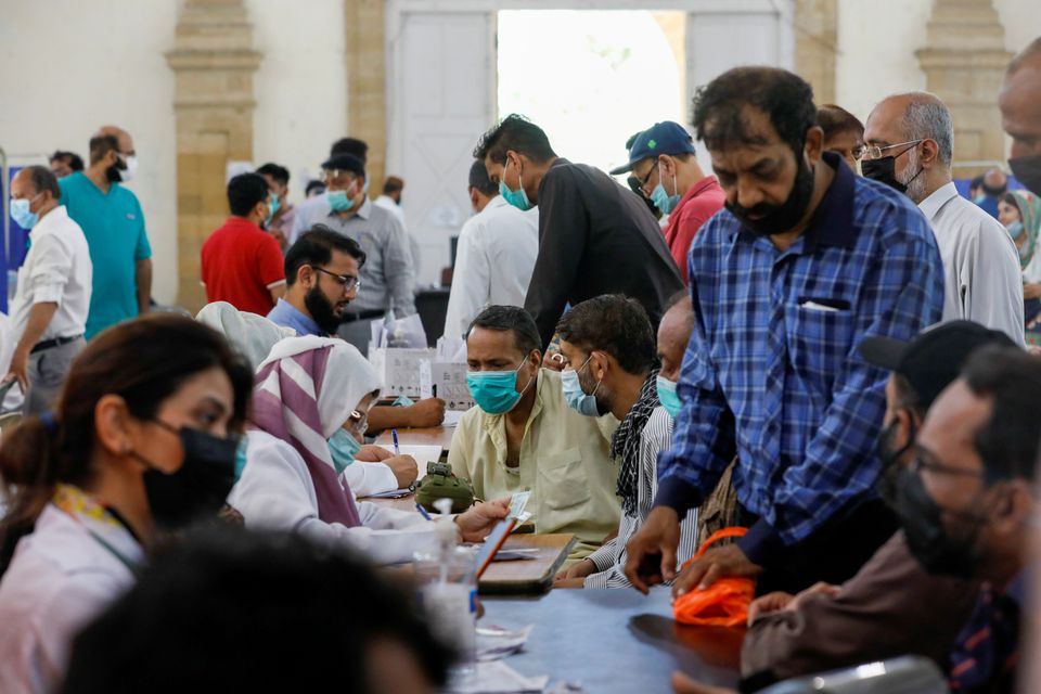 People gather to receive their coronavirus disease (COVID-19) vaccine doses, at a vaccination center in Karachi, Pakistan April 28, 2021. (REUTERS)