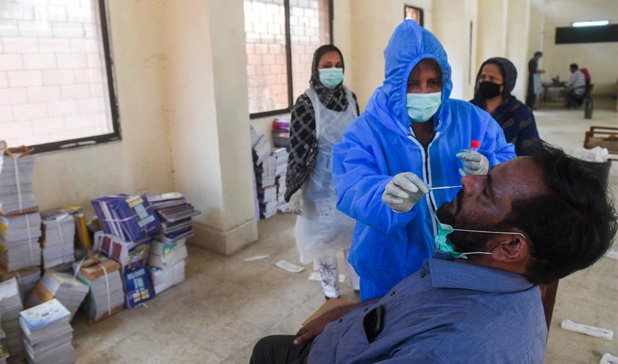A health official collects a swab sample from a person to test for the COVID-19 in Karachi on September 14, 2020. (AFP/ FILE)