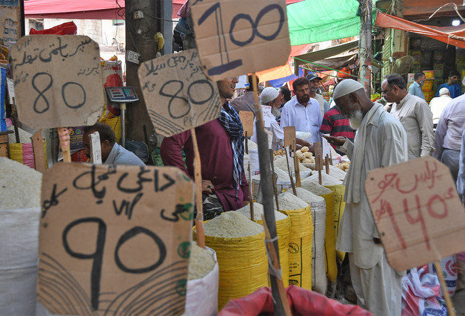 In this picture taken on April 5, 2019, Pakistani customers buy grocery items at a market in Karachi, Pakistan. (AFP/ File)