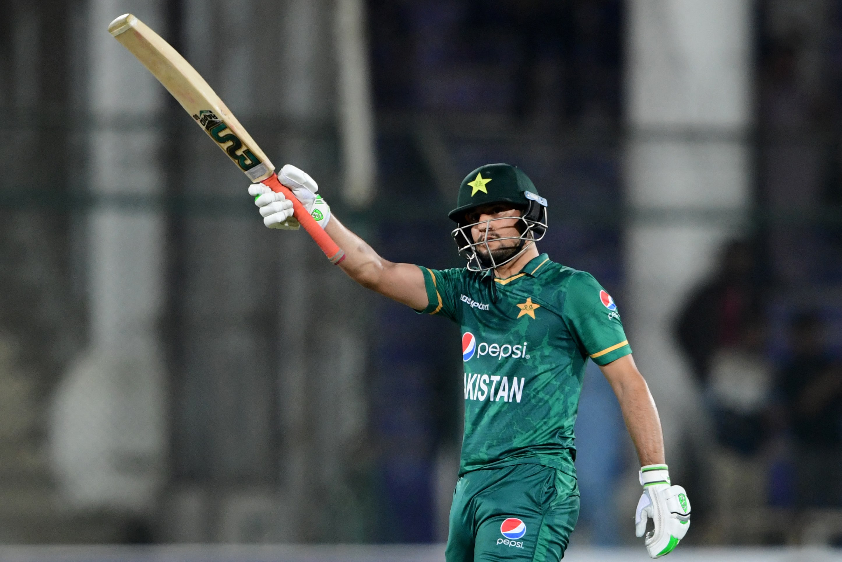 Pakistan's Haider Ali celebrates after scoring a half-century (50 runs) during the first Twenty20 international cricket match between Pakistan and West Indies at the National Stadium in Karachi on December 13, 2021. (AFP)