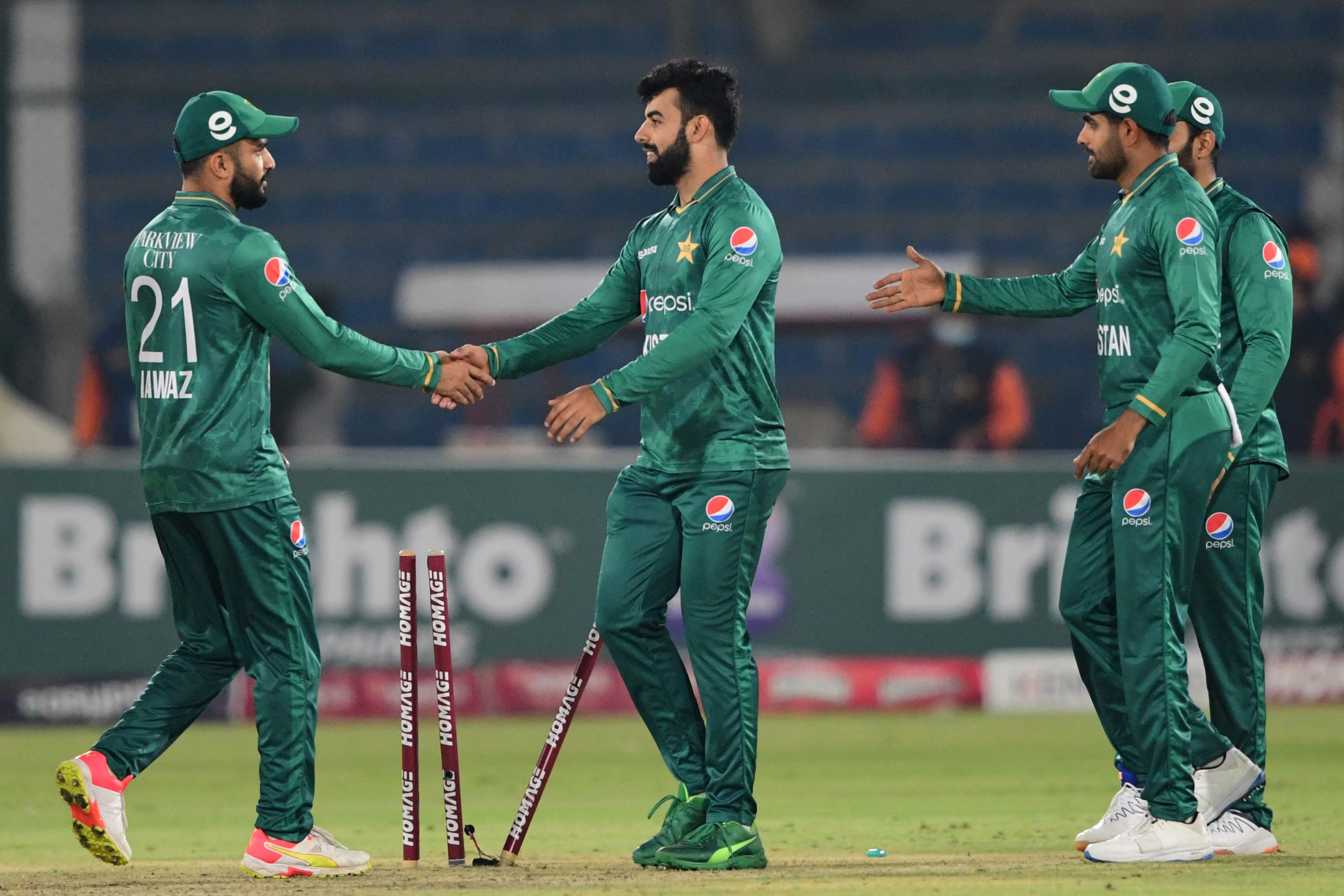 Pakistan's players celebrate their win at the end of the first Twenty20 international cricket match between Pakistan and West Indies at the National Stadium in Karachi on December 13, 2021. (AFP)