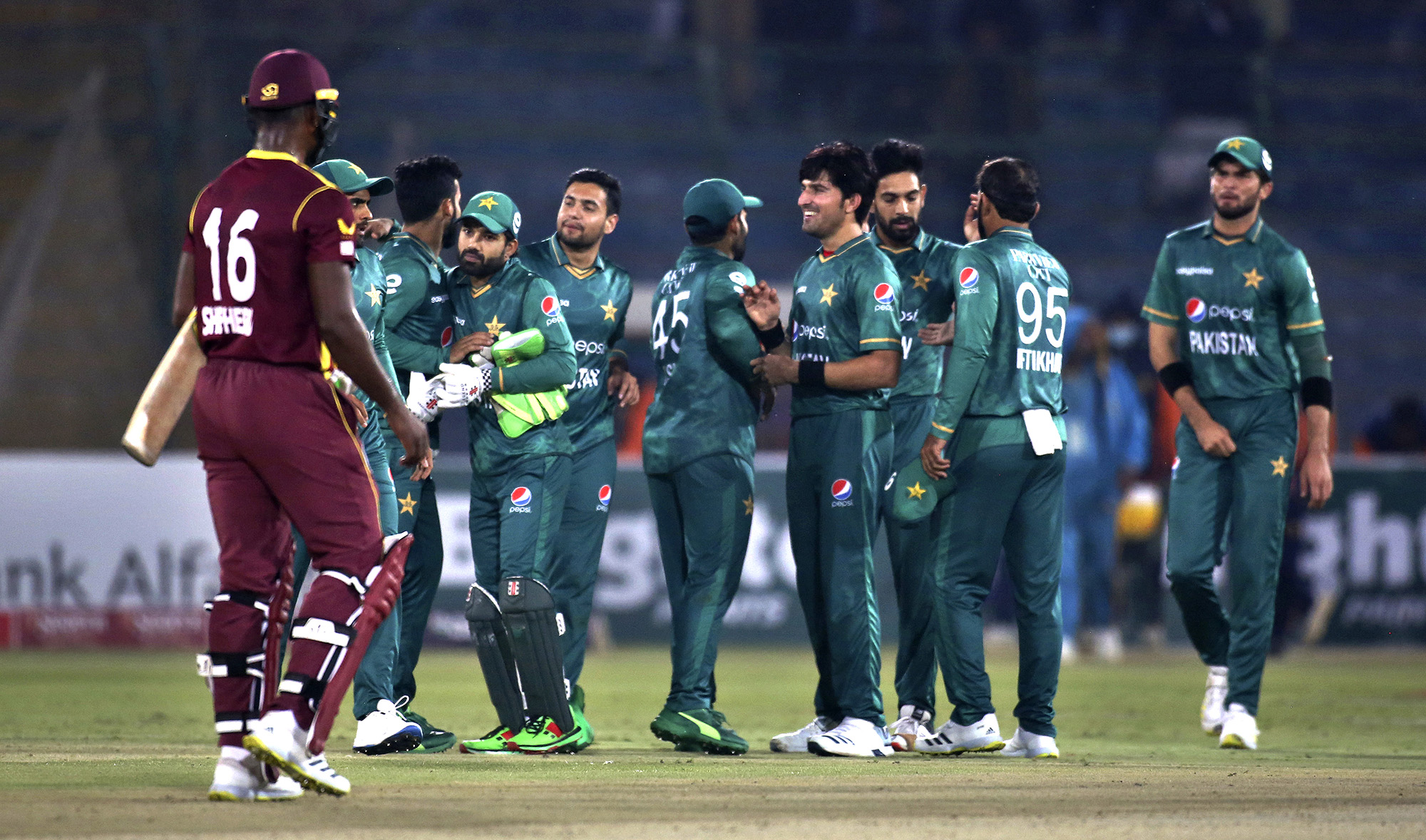 Pakistan's players congratulate each others after winning the second Twenty20 international cricket match against West Indies at the National Stadium, in Karachi, Pakistan on December 14, 2021. (AP)