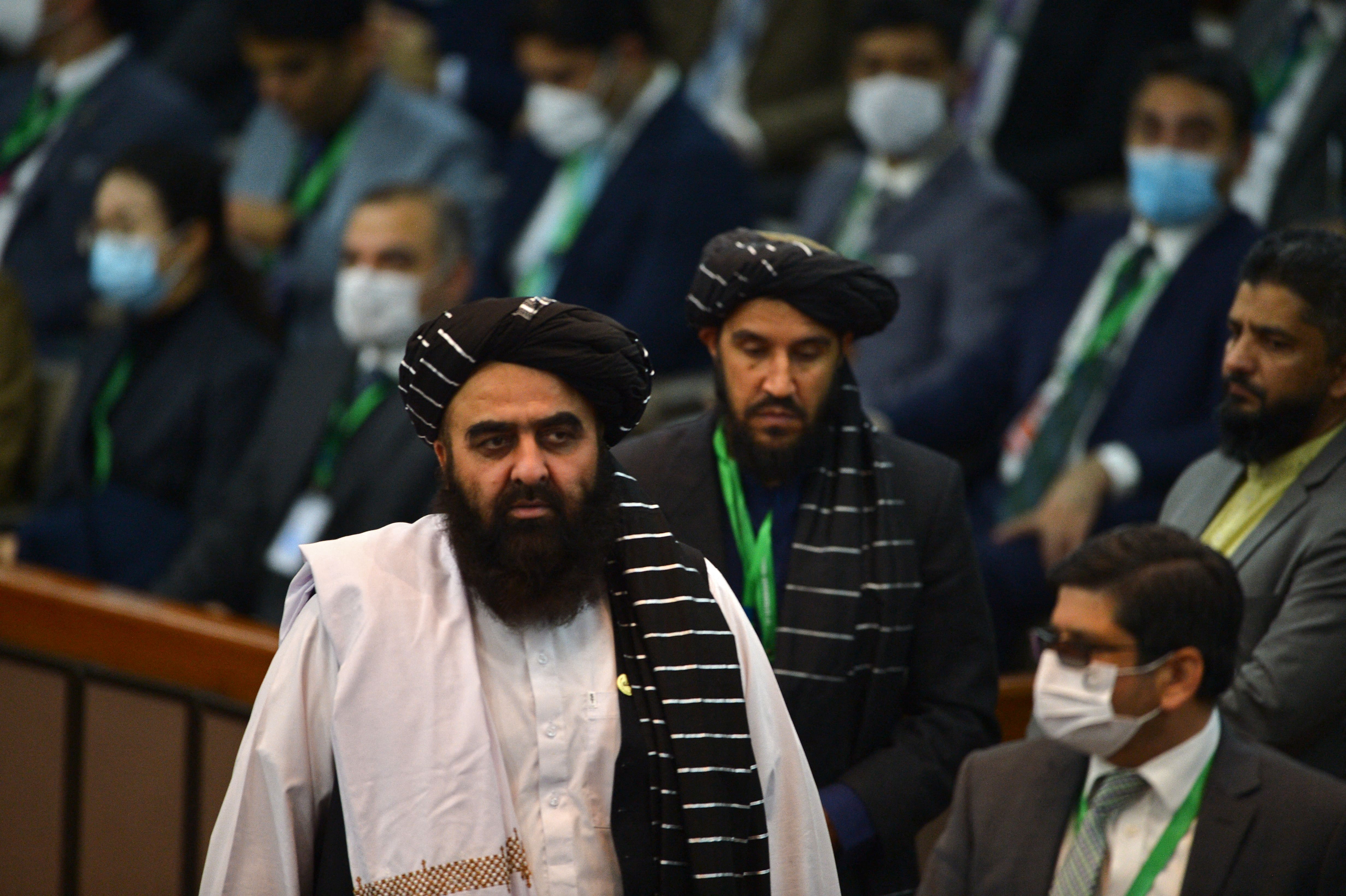 Afghanistan's Taliban Foreign Minister Amir Khan Muttaqi (C) arrives to attend the opening of a special meeting of the 57-member Organisation of Islamic Cooperation (OIC) in Islamabad, Pakistan, on December 19, 2021. (AFP)