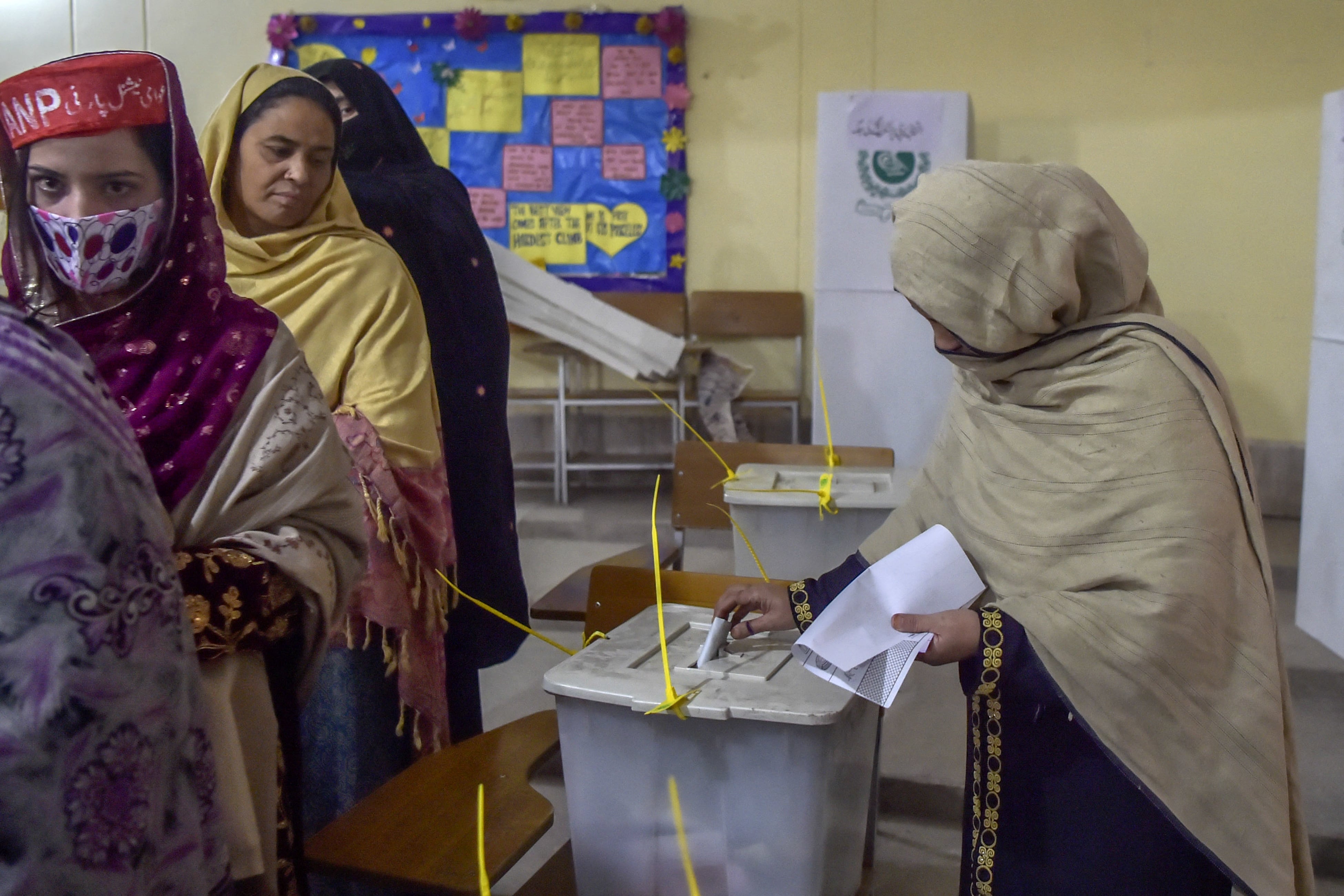 Women stand in a queue inside a polling station during a local body election in Khyber Pakhtunkhwa province of Peshawar on December 19, 2020. (AFP/ File)