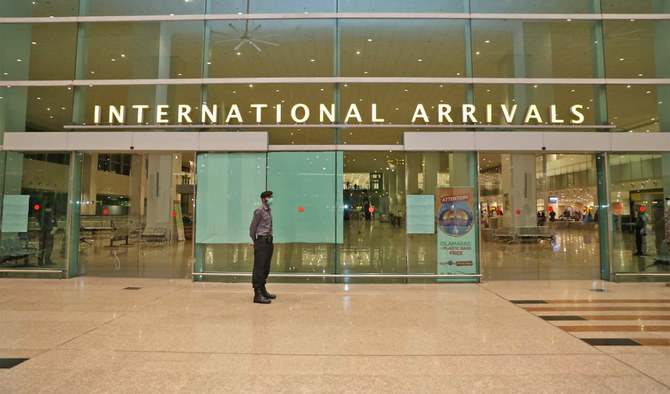 An airport security personnel wearing mask stands guard at Islamabad International Airport on May 5, 2020. (Photo courtesy: @mophrd/Twitter)