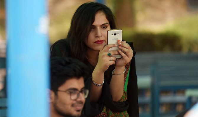 In this picture taken on July 12, 2018, a student uses her mobile phone at a campus in Islamabad, Pakistan. (AFP/File)