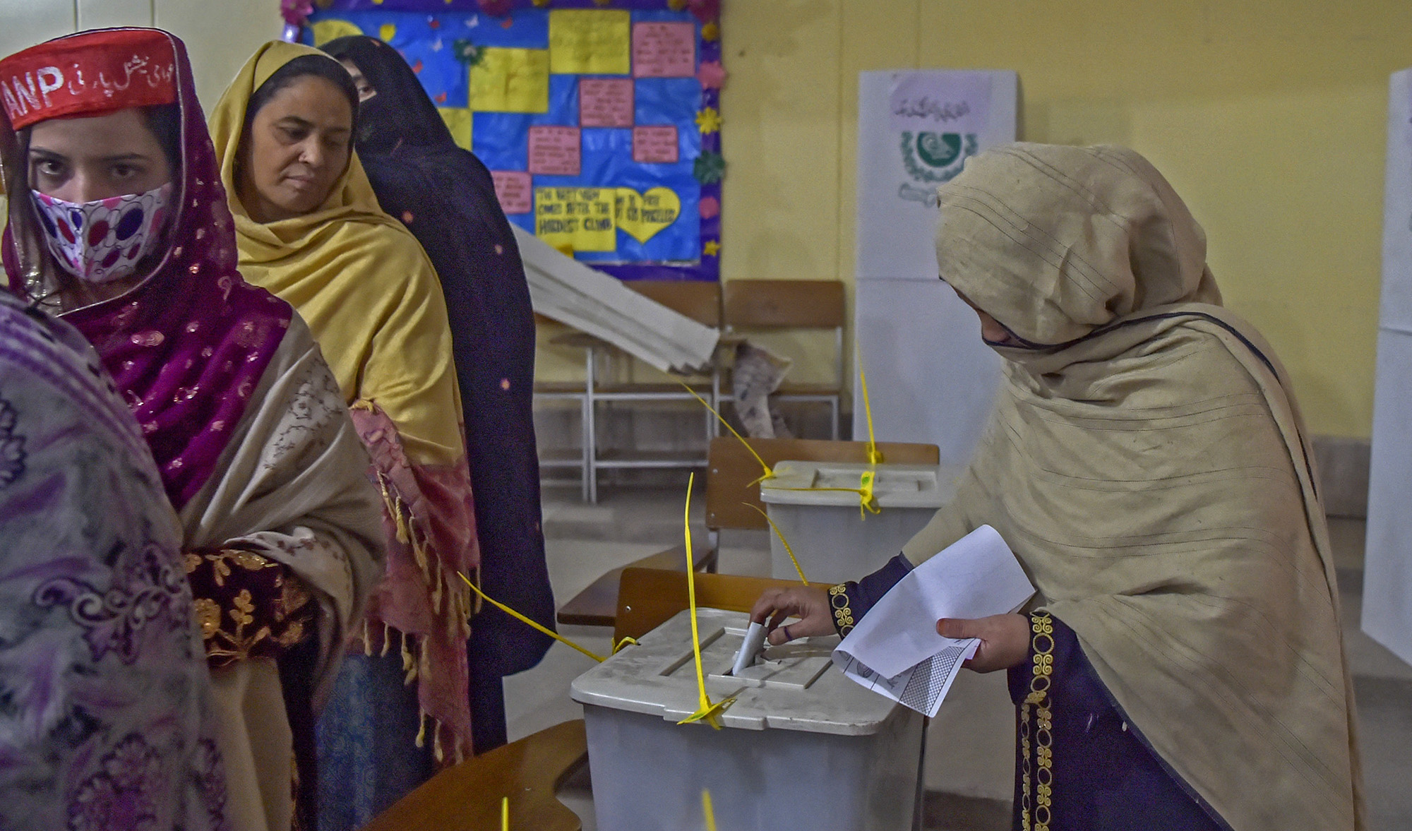 Women stand in a queue inside a polling station during a local body election in Khyber Pakhtunkhwa province of Peshawar, Pakistan, on December 19, 2021. (AFP)