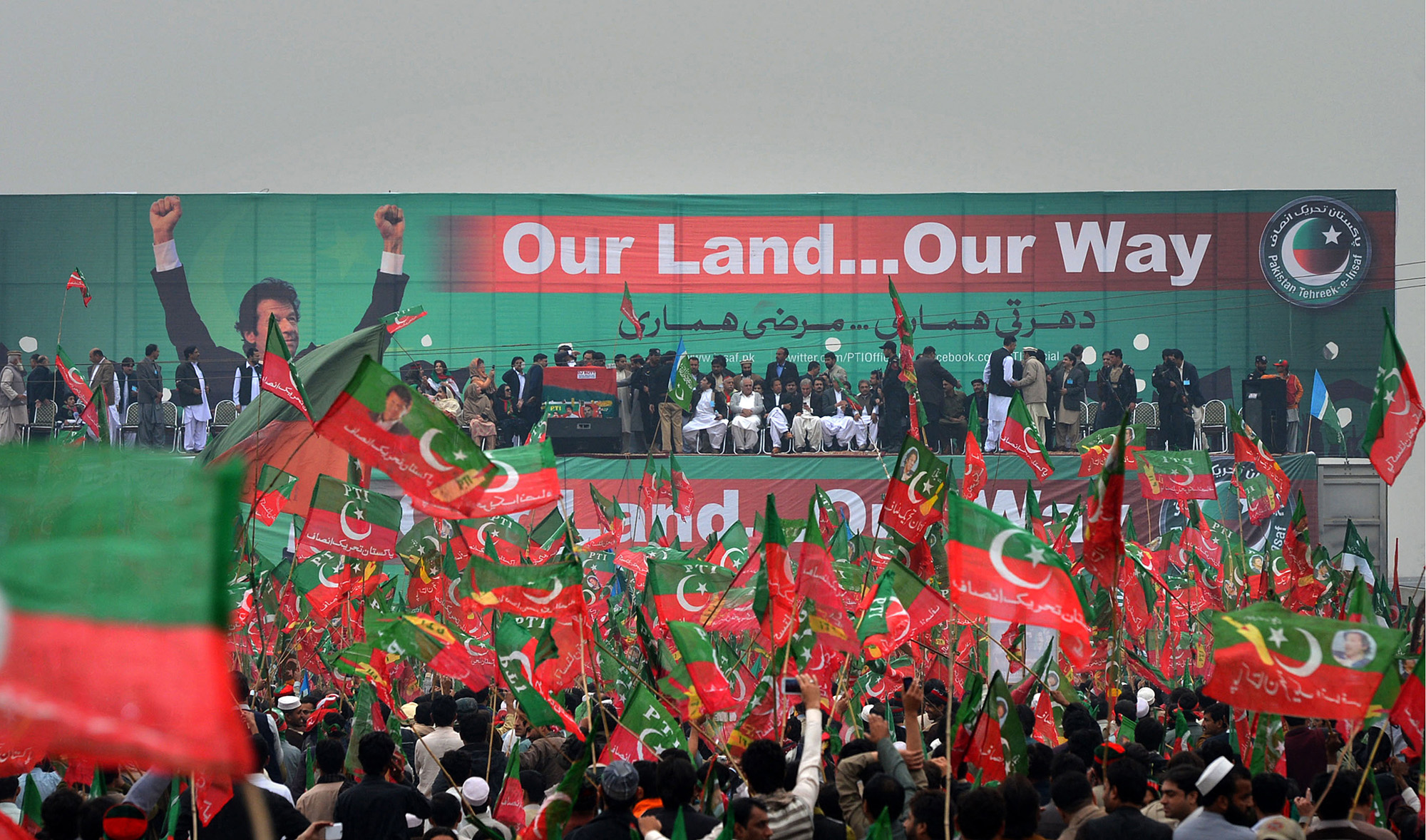 Pakistan Tehreek-e-Insaaf (PTI) activists wave party flags during a rally in Peshawar, Pakistan, on November 23, 2013. (AFP/File)