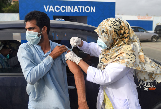 A man receives a dose of vaccine against the coronavirus, during a drive-through vaccination in Karachi, Pakistan, on August 3, 2021. (AFP/File)