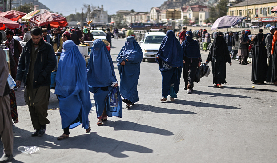 A group of Afghan burqa-clad women walk on a street in Kabul city, on October 29, 2021. (AFP)
