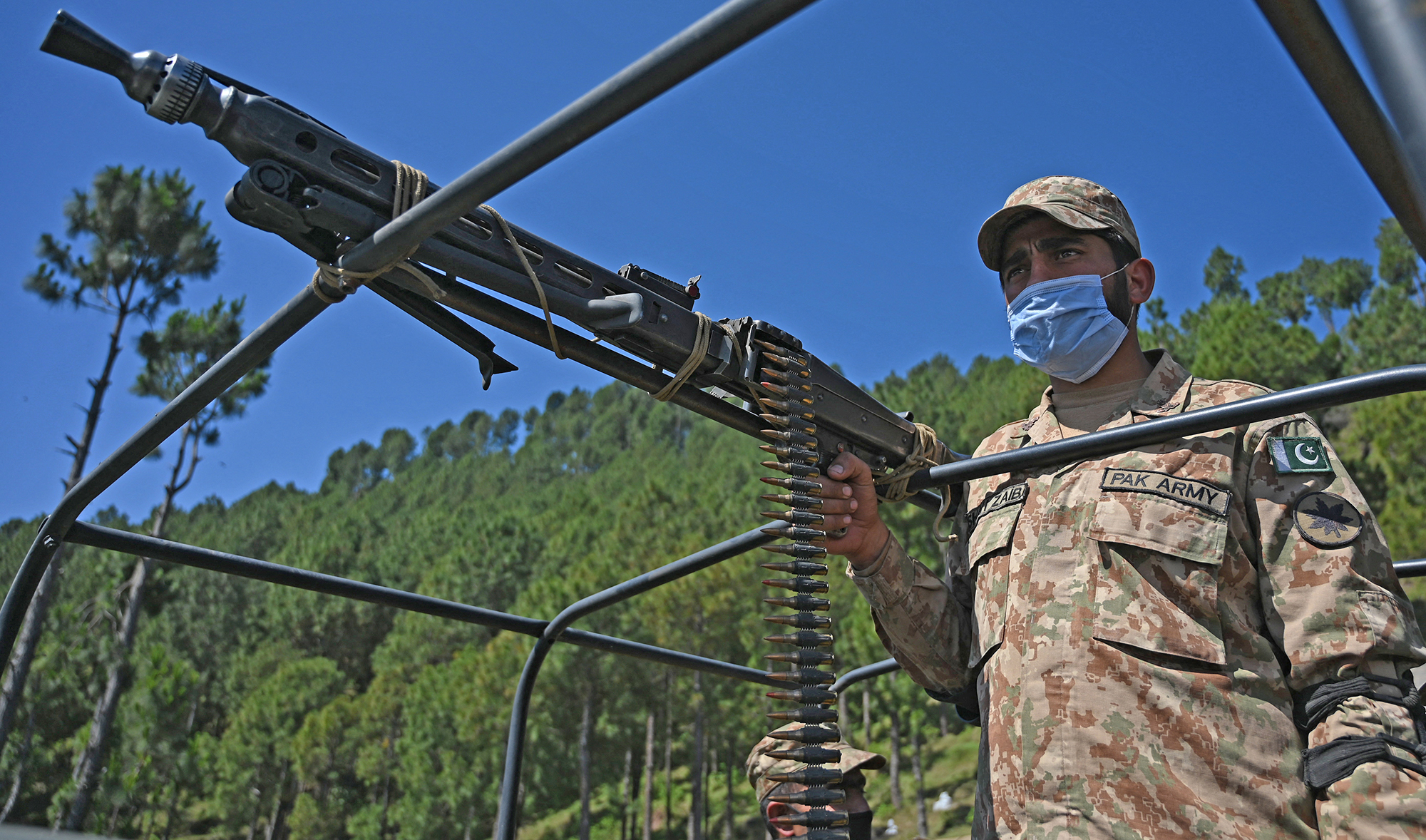 A Pakistani soldier patrols near the Line of Control, de facto border between India and Pakistan at Salohi village in Poonch district of Pakistan-administered Kashmir on April 26, 2021. (AFP)