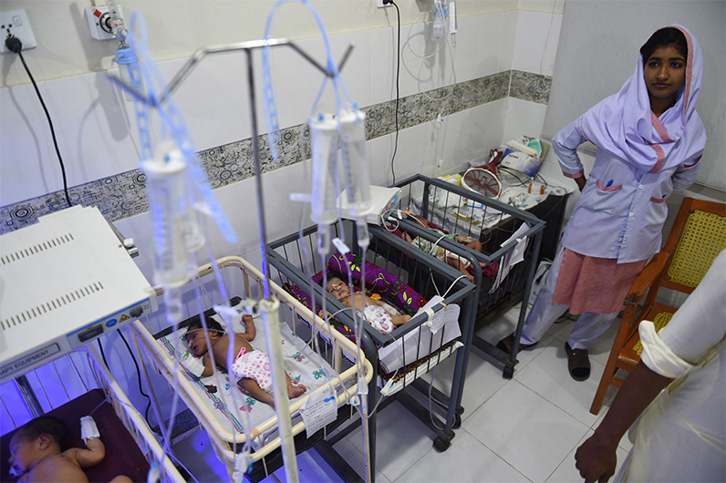 In this picture taken on May 25, 2018, a Pakistani medic takes care of children at Mithi Civil Hospital in Mithi, a remote town in southern Pakistan. (AFP/FILE)