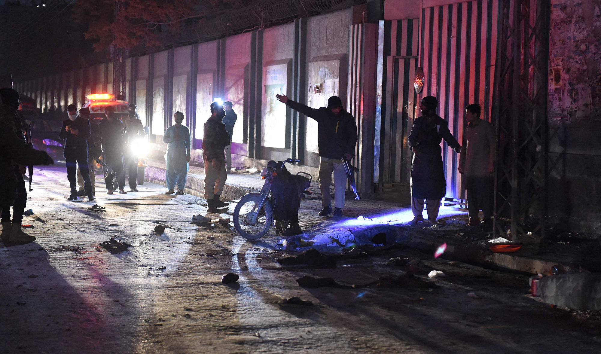 Policemen search for evidence at the site of a bomb blast in Quetta on December 30, 2021. (AFP)
