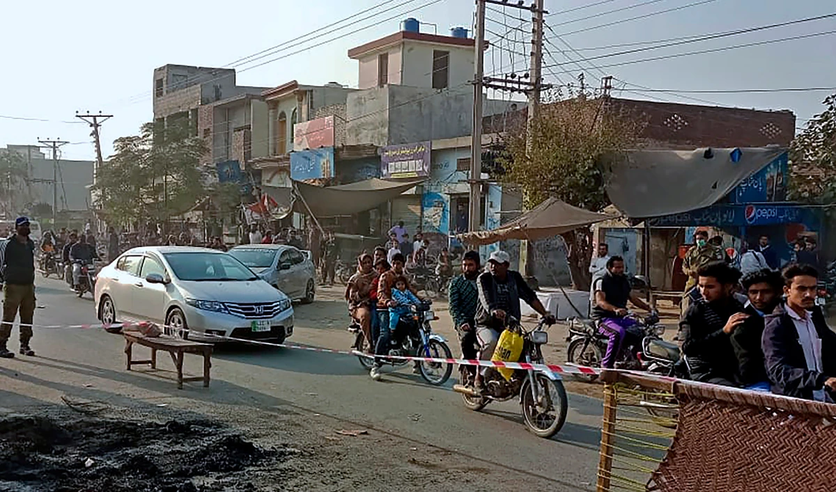 Police officers stand guard at the site where a Sri Lankan citizen lynched by a mob outside a factory in Sialkot, Pakistan on December 3, 2021. (AP)