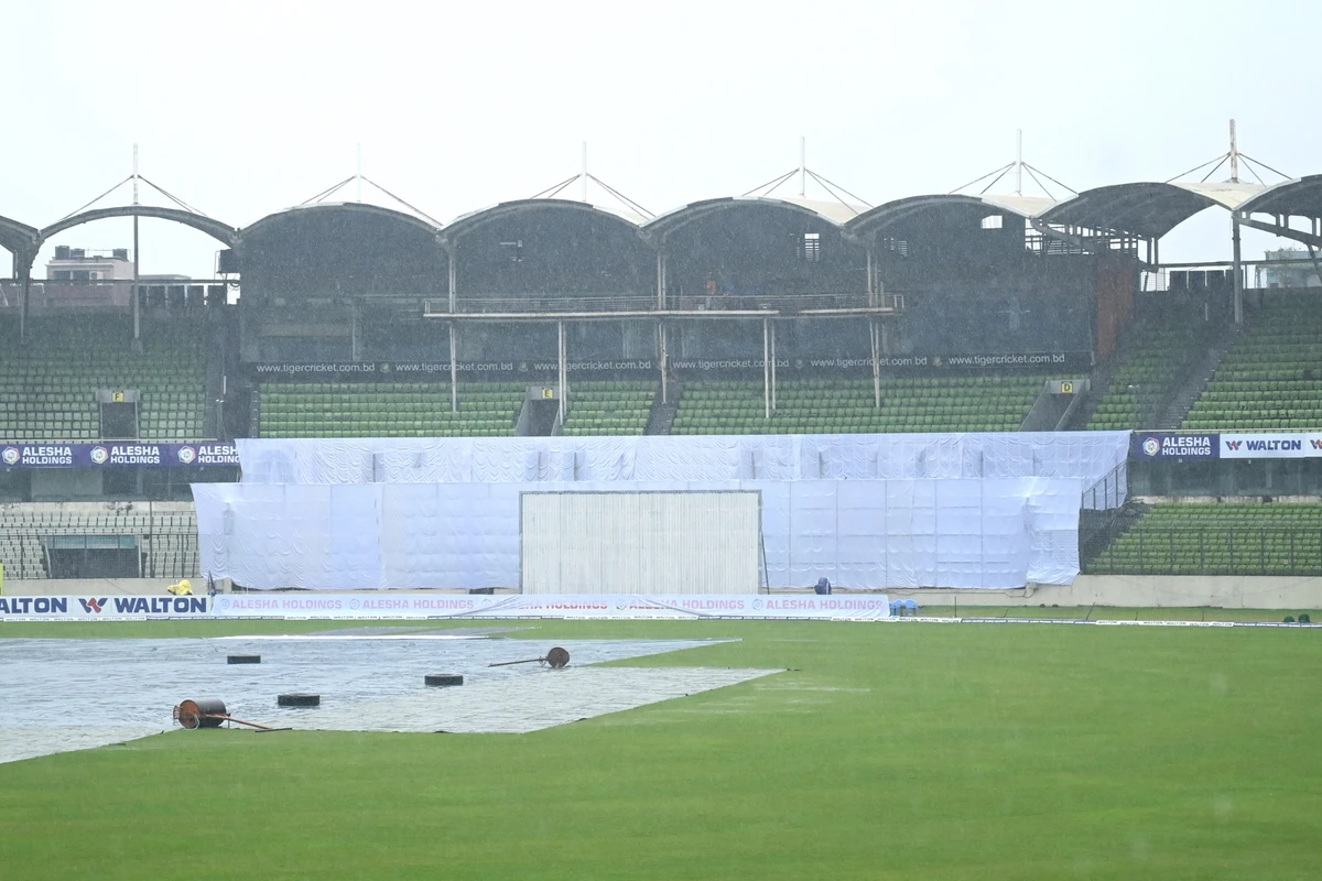 The pitch is covered with plastic sheets as rain interrupts the third day play of the second Test cricket match between Bangladesh and Pakistan at the Sher-e-Bangla National Cricket Stadium in Dhaka on December 6, 2021. (AFP)