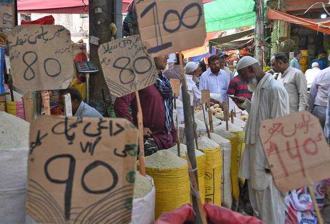In this picture taken on April 5, 2019, Pakistani customers buy grocery items at a market in Karachi, Pakistan. (AFP/ File)