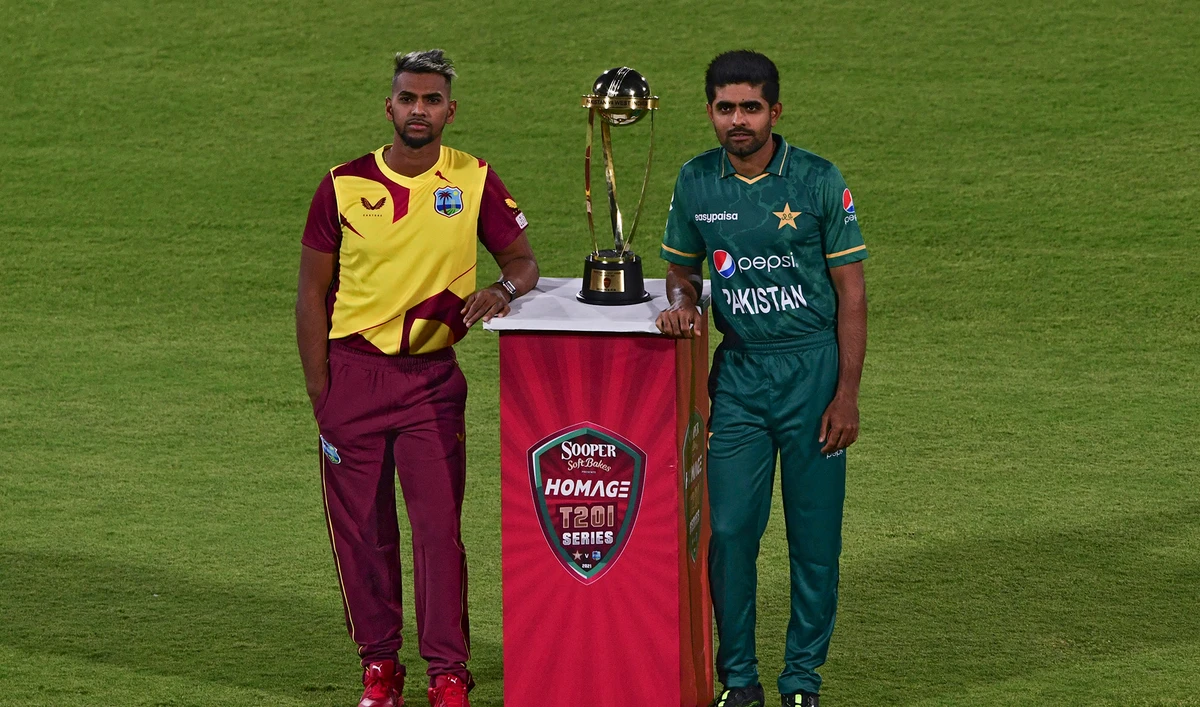 West Indies' captain Nicholas Pooran, left, and Pakistan's captain Babar Azam pose with the T20 trophy before the start of a practice session at the National Stadium in Karachi on December 12, 2021. (AFP)