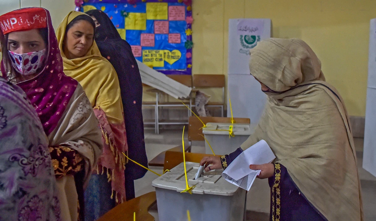 Women stand in a queue inside a polling station during a local body election in Khyber Pakhtunkhwa province of Peshawar, Pakistan, on December 19, 2021. (AFP)