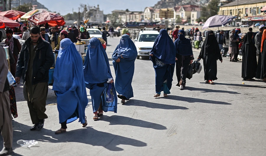 A group of Afghan burqa-clad women walk on a street in Kabul city, on October 29, 2021. (AFP)