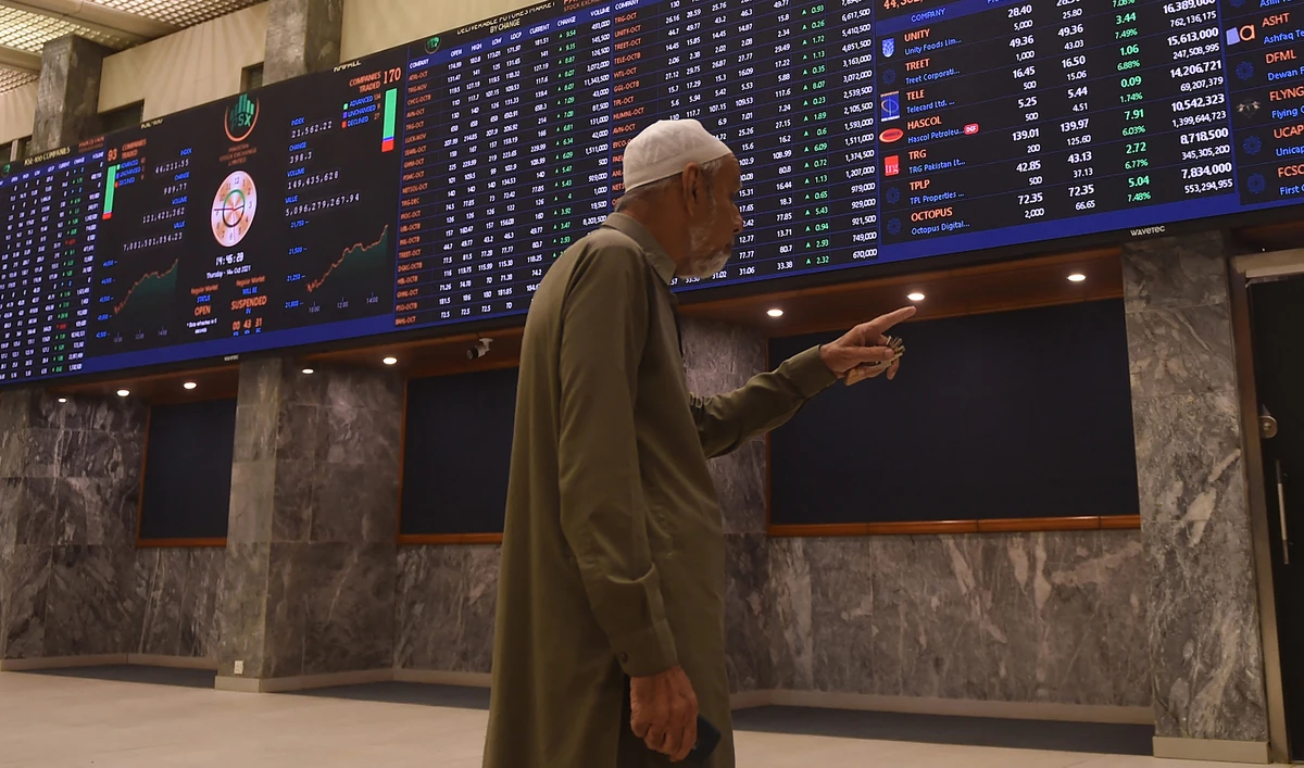 A stockbroker watches an index board showing the latest share prices during a trading session at the Pakistan Stock Exchange (PSX) in Karachi on October 14, 2021. (AFP/File)