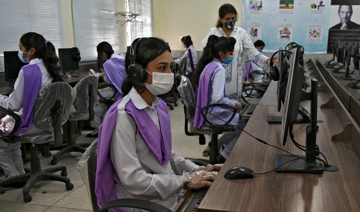 Students wearing facemasks attend a computer class at the Islamabad Model College of Commerce for Girls in Islamabad, Pakistan, on September 15, 2020. (AFP/File)