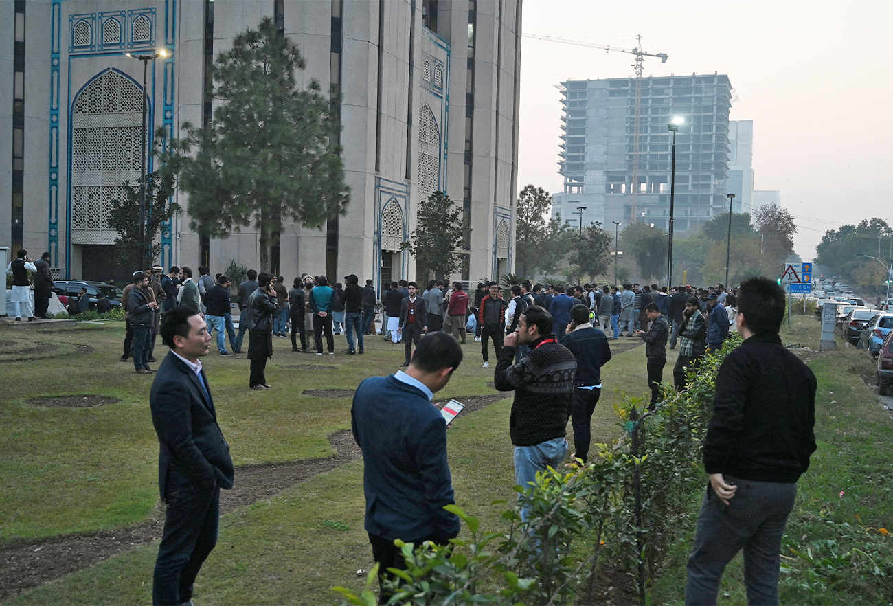 People gather outside buildings after an earthquake in Islamabad, Pakistan, on December 20, 2019. (AFP/File)