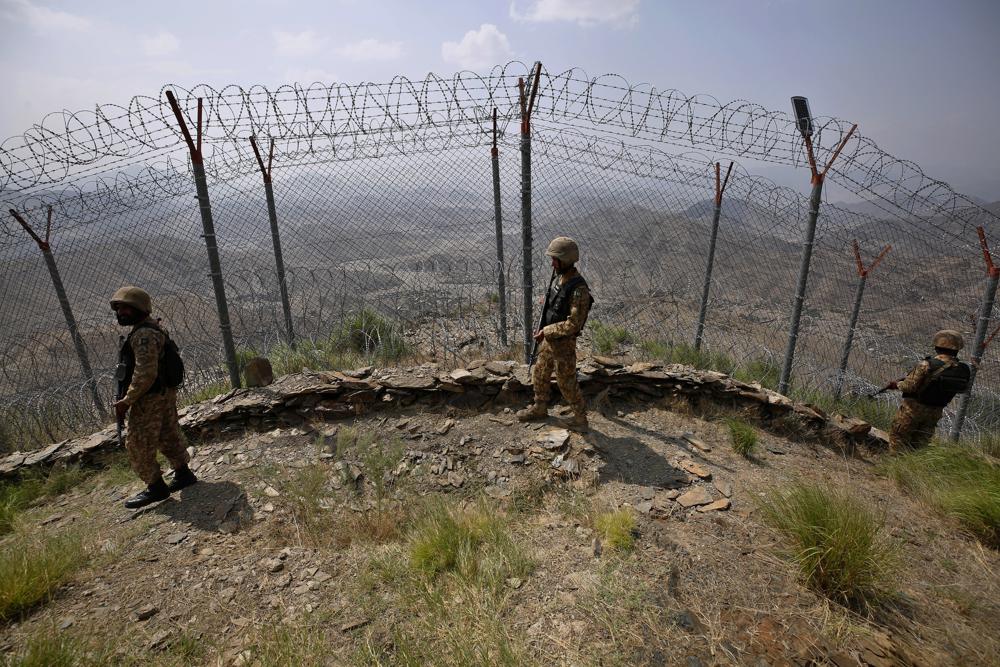 Pakistan Army troops patrol along the fence on the Pakistan Afghanistan border at Big Ben hilltop post in Khyber district, Pakistan, Aug. 3, 2021. (AP)