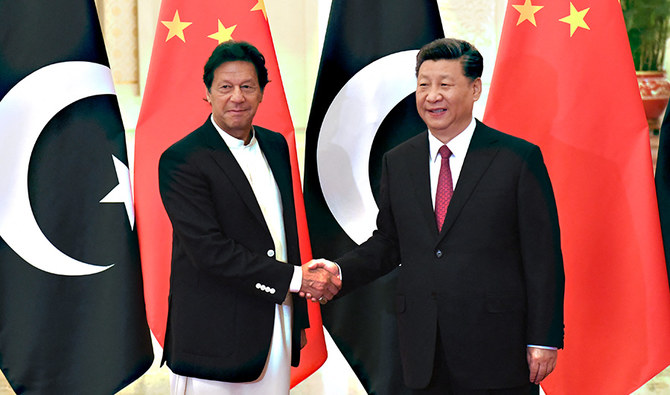 China's President Xi Jinping (R) shakes hands with Pakistan's Prime Minister Imran Khan (L) before their meeting at the Great Hall of the People in Beijing on April 28, 2019. (AFP/File)