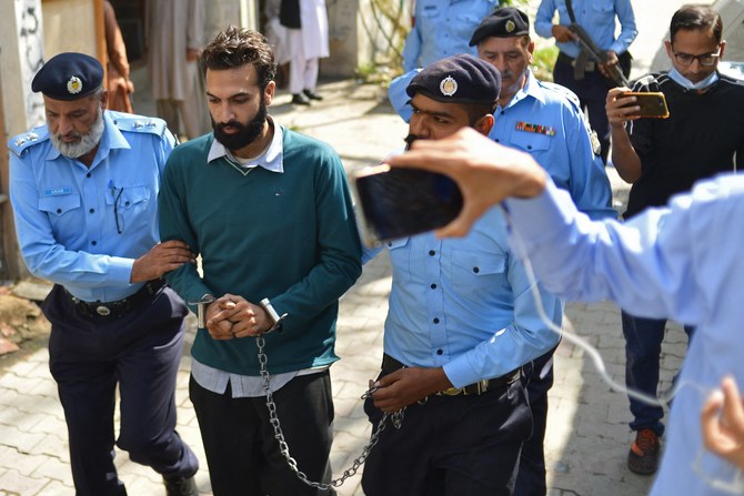 Policemen escort Zahir Jaffer (2L), a Pakistani-American man who went on trial accused of raping and beheading his girlfriend, the daughter of a former ambassador, after his court hearing in Islamabad on October 20, 2021. (AFP)